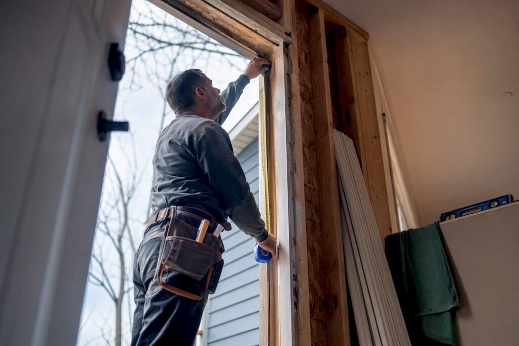 Installer measuring a door rough opening